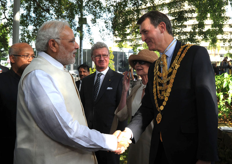 P M Narendra Modi being received at a programme to unveil statue of Mahatma Gandhi